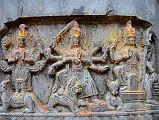 Kathmandu Changu Narayan 29 Vishnu, Durga, And Shiva Carvings On A Stone In Front Of The North Entrance To Changu Narayan Temple Vishnu, Durga, and Shiva are carved on a stone in front of the north entrance to Changu Narayan Temple. Vishnu has four arms and holds the disc and mace / club. Durga has eight arms and holds the sword, damaru drum, trident, and disc. Shiva has four arms and holds a damaru drum, a trident, and a small water pot.